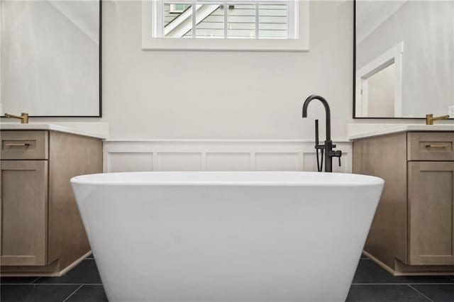 591 Brashy St, Woodstock, GA 30188 - full bath featuring tile patterned flooring, vanity, a freestanding tub, a decorative wall, and wainscoting