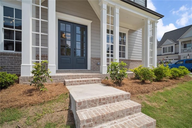 591 Brashy St, Woodstock, GA 30188 - doorway to property with brick siding, a porch, and french doors