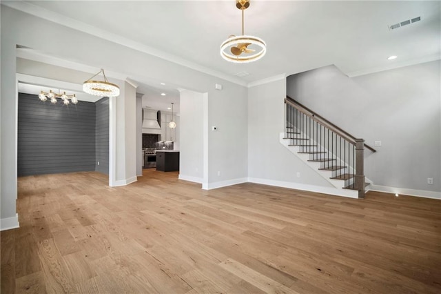 591 Brashy St, Woodstock, GA 30188 - unfurnished living room with a chandelier, stairway, light wood finished floors, ornamental molding, and baseboards
