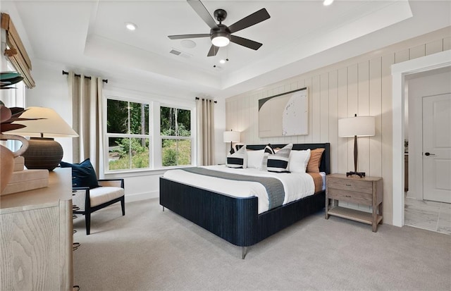 bedroom featuring a tray ceiling, recessed lighting, visible vents, and light colored carpet