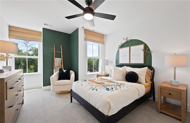 bedroom with a ceiling fan, carpet flooring, visible vents, and baseboards