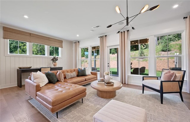 living room with recessed lighting, visible vents, a notable chandelier, and wood finished floors