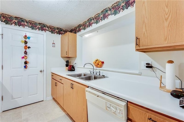 kitchen with a textured ceiling, white dishwasher, a sink, light countertops, and light brown cabinets