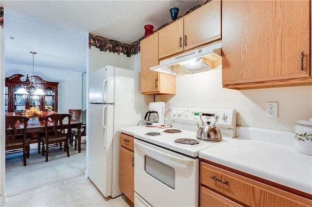 kitchen with light countertops, under cabinet range hood, a notable chandelier, and white appliances
