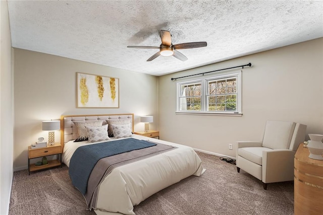 bedroom with ceiling fan, carpet floors, baseboards, and a textured ceiling