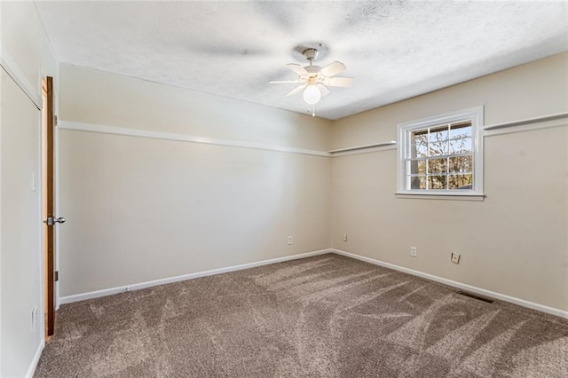 carpeted spare room featuring ceiling fan, baseboards, visible vents, and a textured ceiling