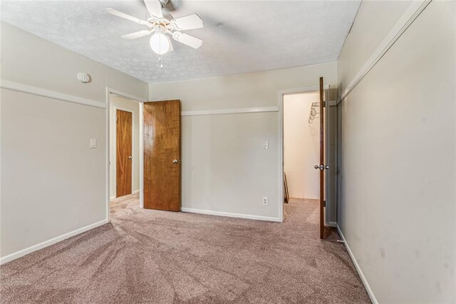 1106 Hampton Way NE, Atlanta, GA 30324 - unfurnished bedroom featuring carpet, a textured ceiling, baseboards, a closet, and ceiling fan