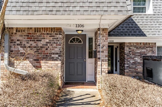 1106 Hampton Way NE, Atlanta, GA 30324 - doorway to property featuring roof with shingles and brick siding