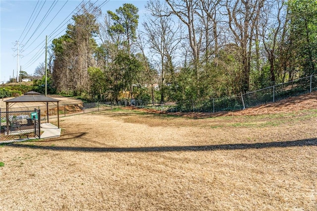 view of community featuring a gazebo, a yard, and fence