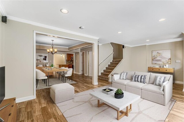 1106 Hampton Way NE, Atlanta, GA 30324 - living room with stairway, wood finished floors, a chandelier, ornamental molding, and baseboards