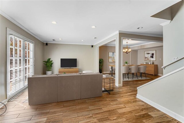 1106 Hampton Way NE, Atlanta, GA 30324 - living room with ornamental molding, plenty of natural light, a chandelier, light wood finished floors, and recessed lighting