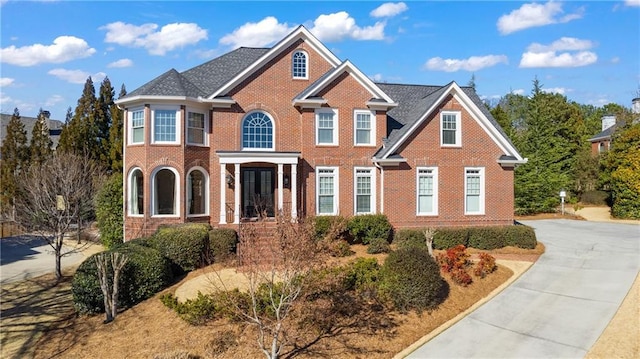 view of front of property with concrete driveway and brick siding