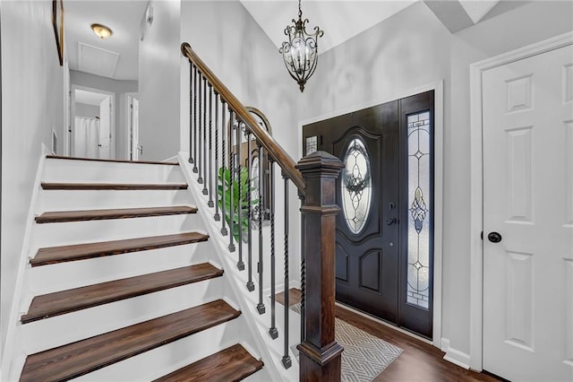 foyer featuring stairway, baseboards, and wood finished floors