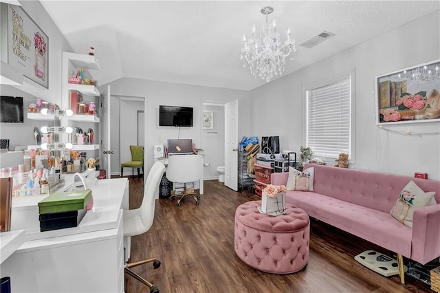 office space with a textured ceiling, wood finished floors, visible vents, and an inviting chandelier