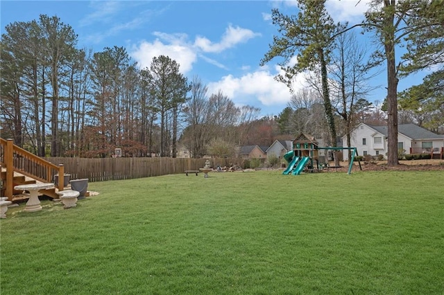 view of yard featuring fence and a playground