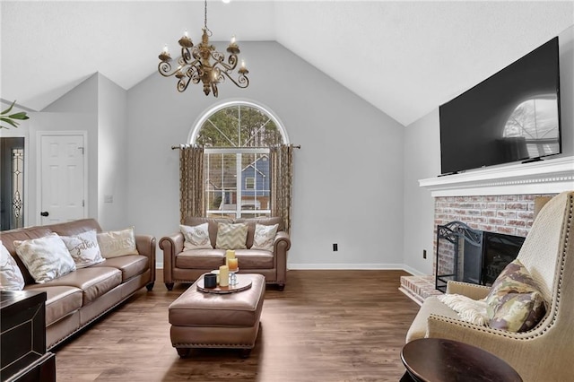 living room featuring lofted ceiling, a brick fireplace, wood finished floors, and baseboards