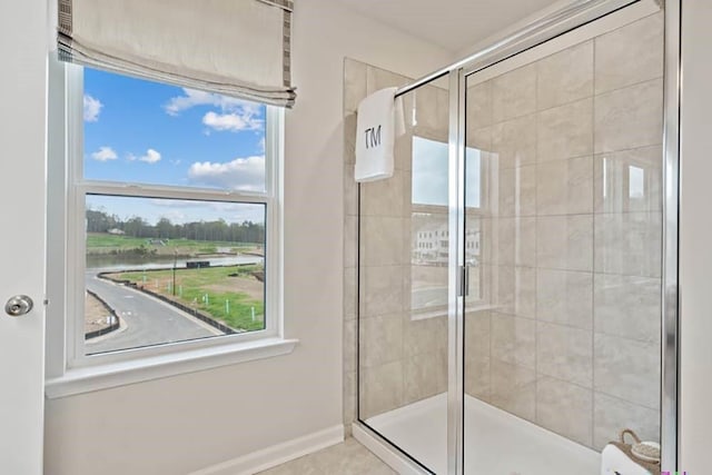 bathroom featuring a water view and an enclosed shower