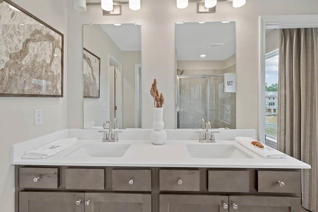 bathroom featuring vanity and a shower with door