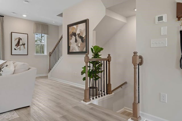 stairway featuring wood-type flooring