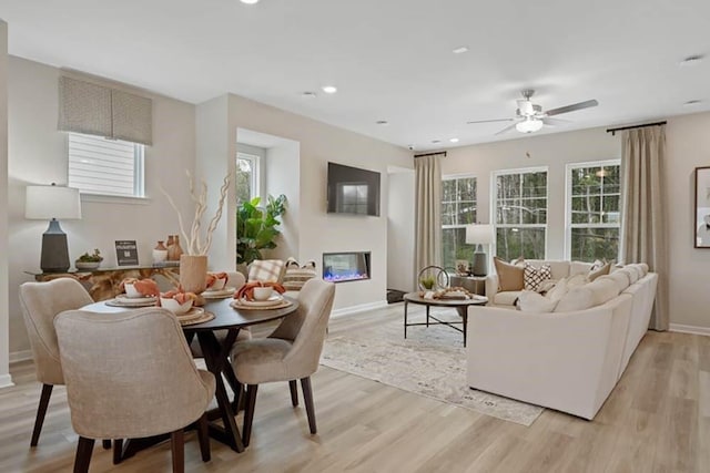 interior space with ceiling fan and light hardwood / wood-style flooring