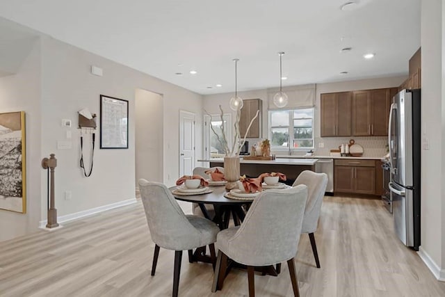 dining space with light hardwood / wood-style flooring