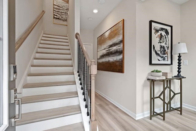 staircase with hardwood / wood-style floors