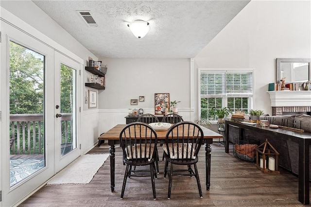 119 Ashley Way, Jefferson, GA 30549 - dining room with french doors, wood finished floors, healthy amount of natural light, a textured ceiling, and a wainscoted wall