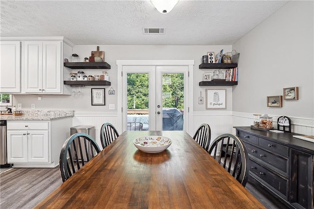 119 Ashley Way, Jefferson, GA 30549 - dining area featuring a textured ceiling, a wainscoted wall, wood finished floors, and french doors