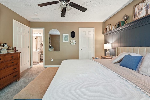 119 Ashley Way, Jefferson, GA 30549 - carpeted bedroom featuring a textured ceiling, ensuite bathroom, ceiling fan, and baseboards