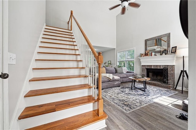 119 Ashley Way, Jefferson, GA 30549 - stairs with a high ceiling, ceiling fan, wood finished floors, and a fireplace