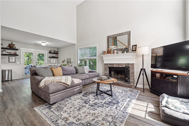 119 Ashley Way, Jefferson, GA 30549 - living area featuring wood finished floors, a fireplace, french doors, and a high ceiling