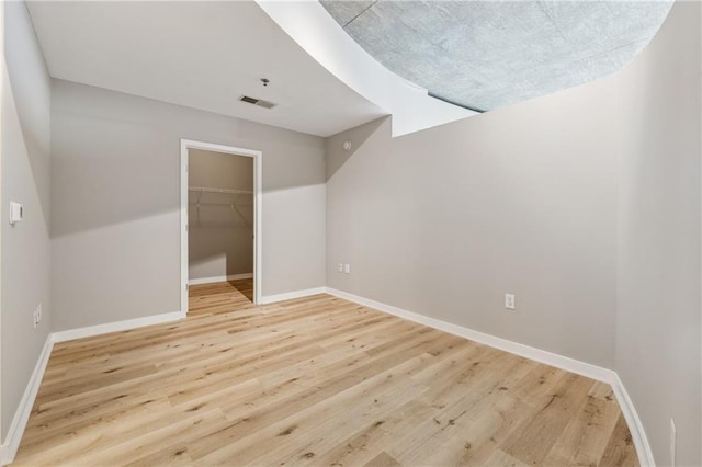 additional living space featuring light wood-style floors and baseboards