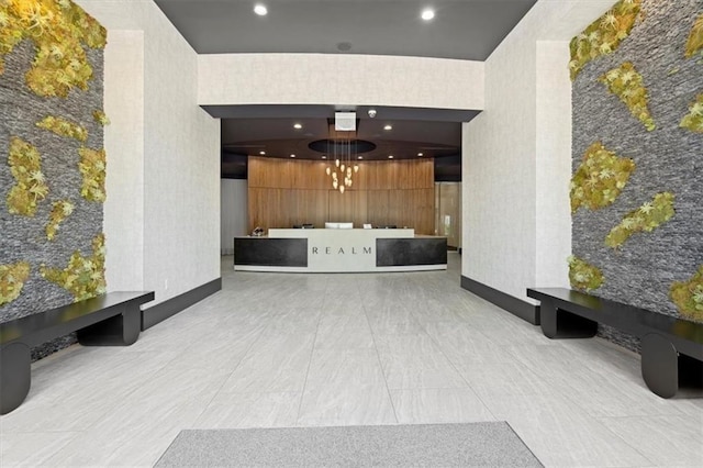 welcome area with wallpapered walls, recessed lighting, and a chandelier