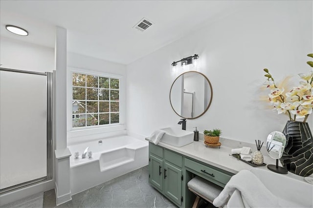 bathroom with vanity and shower with separate bathtub