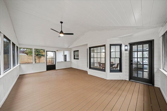 unfurnished sunroom with ceiling fan and vaulted ceiling