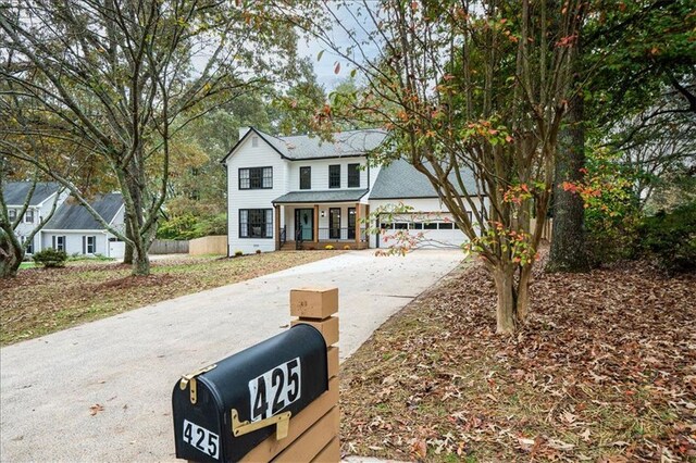 view of front of property featuring a porch and a garage