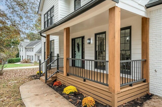 view of exterior entry with covered porch