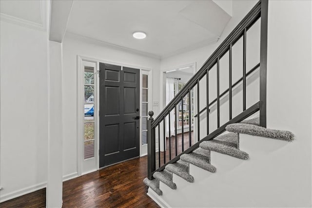 entrance foyer featuring dark hardwood / wood-style flooring and ornamental molding