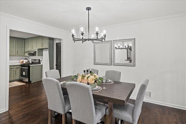 dining area with dark hardwood / wood-style flooring, ornamental molding, and an inviting chandelier