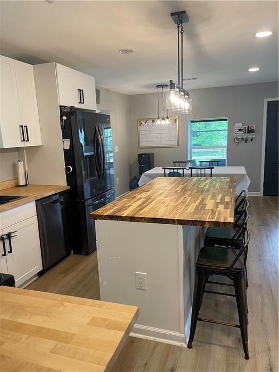 433 Spring Place Reseca Rd, Resaca, GA 30735 - kitchen featuring wooden counters, black appliances, white cabinetry, a center island, and light wood-style floors