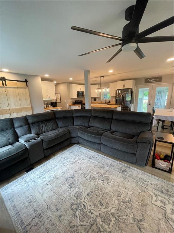 433 Spring Place Reseca Rd, Resaca, GA 30735 - living room with ceiling fan, a barn door, recessed lighting, and wood finished floors
