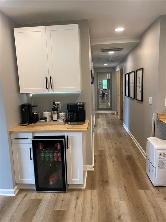 433 Spring Place Reseca Rd, Resaca, GA 30735 - indoor bar with beverage cooler, light wood-style flooring, baseboards, and recessed lighting