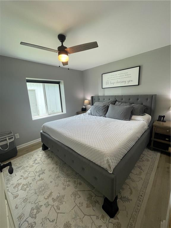 433 Spring Place Reseca Rd, Resaca, GA 30735 - bedroom featuring wood finished floors, a ceiling fan, and baseboards