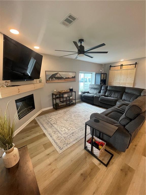 433 Spring Place Reseca Rd, Resaca, GA 30735 - living area featuring a ceiling fan, wood finished floors, a barn door, recessed lighting, and baseboards