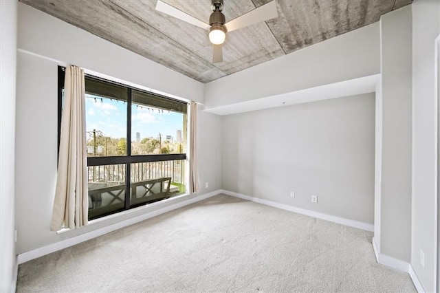 unfurnished room featuring ceiling fan and carpet