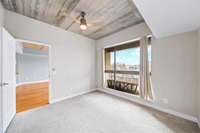 spare room featuring carpet floors and ceiling fan