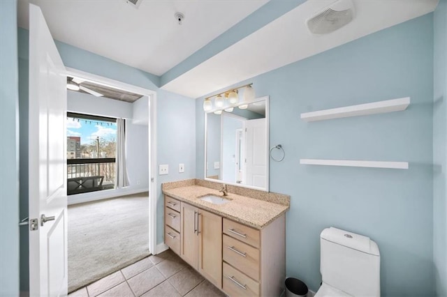 bathroom with vanity, tile patterned floors, and toilet