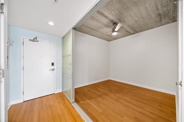 foyer entrance with wood-type flooring and ceiling fan