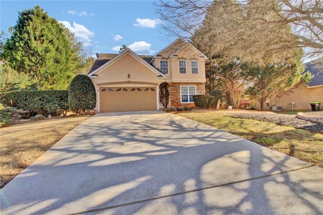 view of front of property with a garage, driveway, and stucco siding