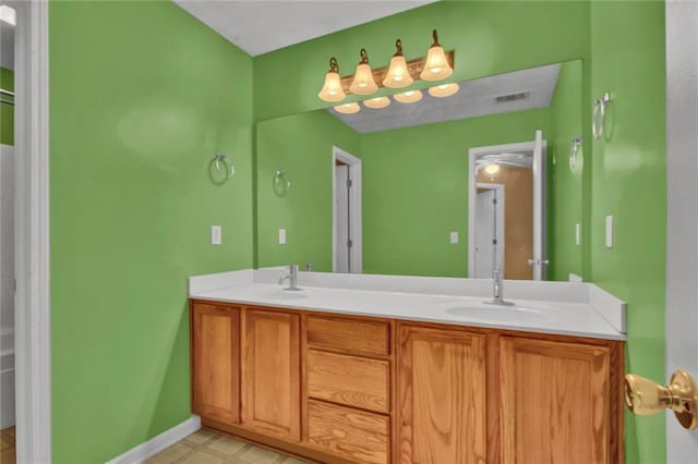 full bathroom featuring double vanity, visible vents, baseboards, and a sink